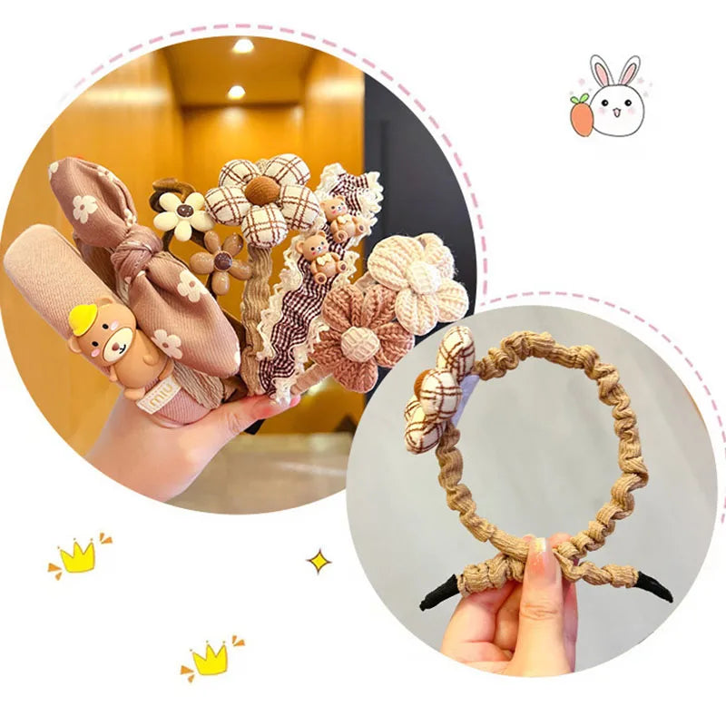 Set of decorative headbands with floral and animal designs, held by a hand.